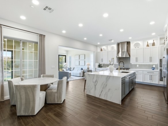 Image of a luxury home open living space with white wall, furniture, and countertops.