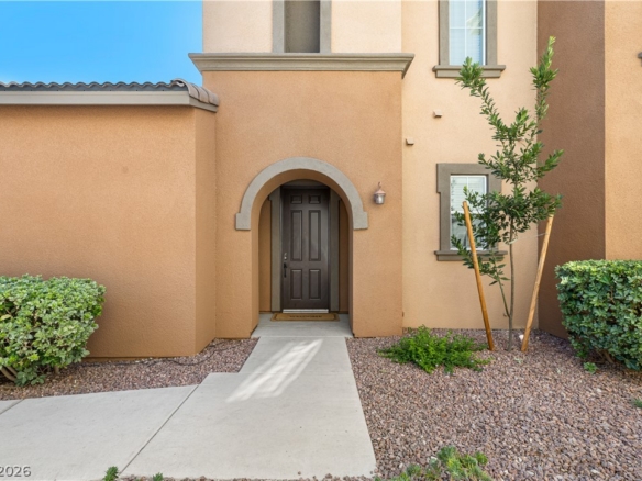 Exterior entrance of a Henderson condominium with stucco architecture and desert landscaping, illustrating a Las Vegas condo financing and HOA reserve article.