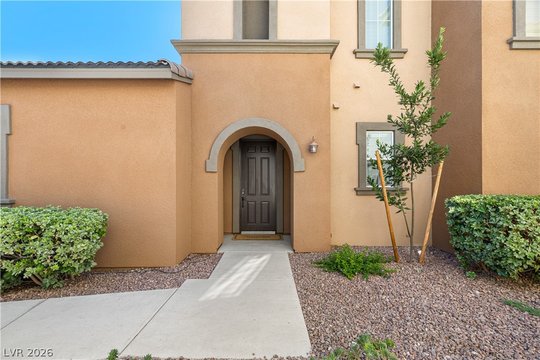 Exterior entrance of a Henderson condominium with stucco architecture and desert landscaping, illustrating a Las Vegas condo financing and HOA reserve article.