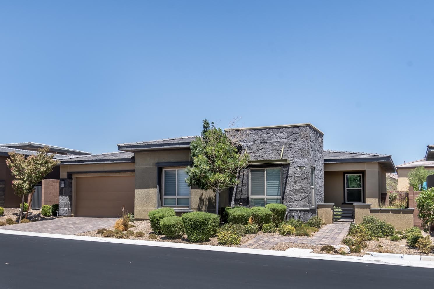 Contemporary single-story home at 9868 Gemstone Sunset Avenue in Regency at Summerlin, a 55+ community in Las Vegas.